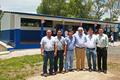 Equipo de COEX frente a las nuevas aulas para El Centro Escolar.